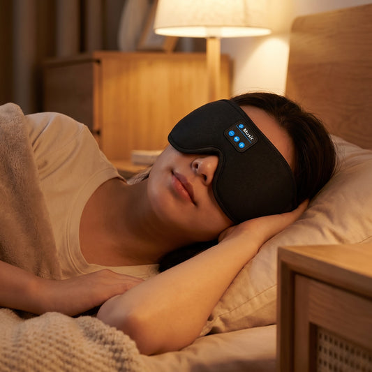 Woman sleeping in a NapNest Bluetooth sleep mask with built-in speakers